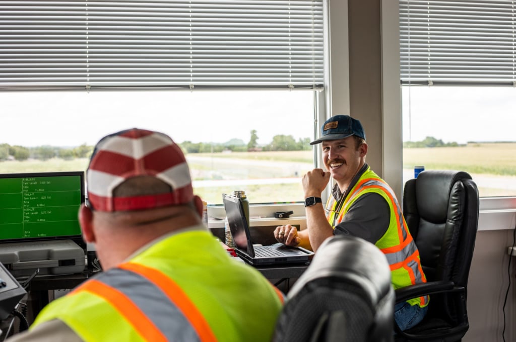 Lauren concrete batch personnel in the office, smiling and talking