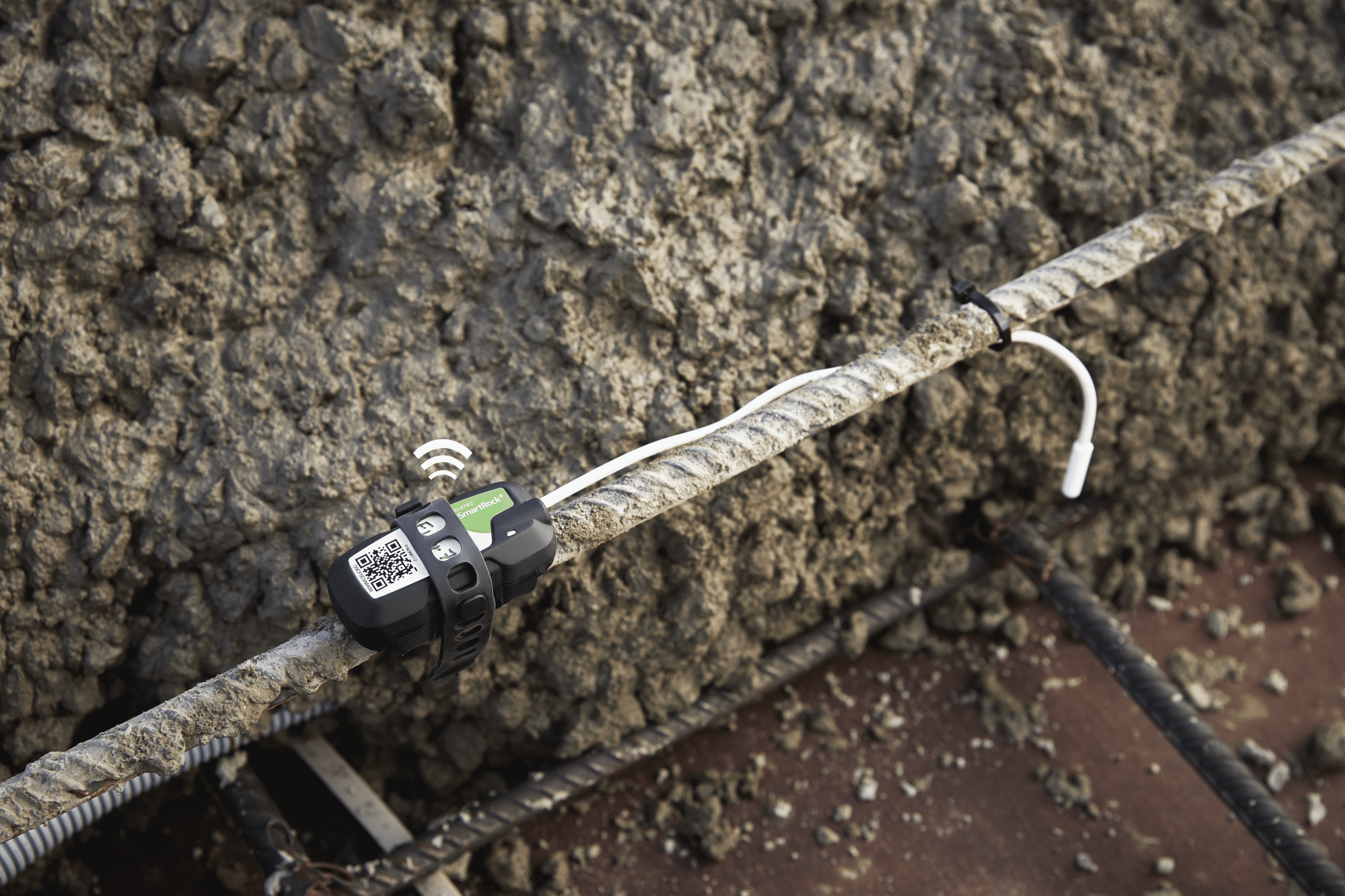 SmartRock sensor on rebar collecting real-time concrete temperature and strength data